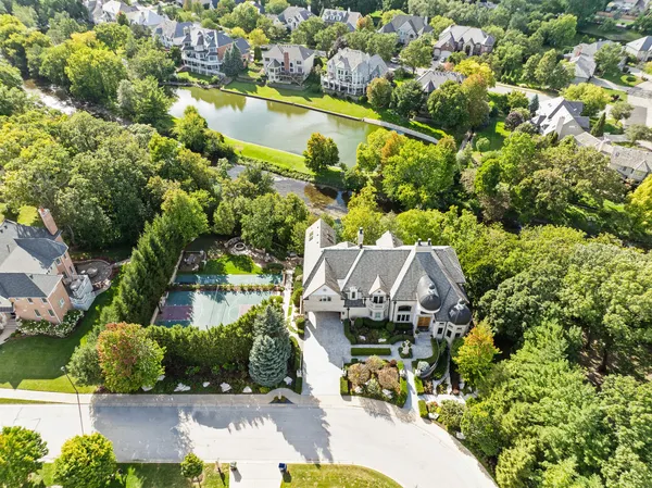 an aerial view of a house with a garden and swimming pool