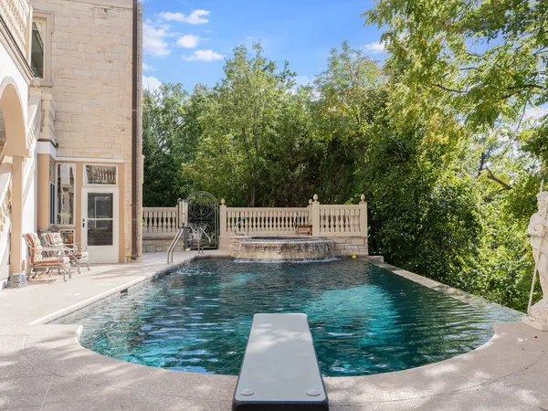 swimming pool view with a garden space
