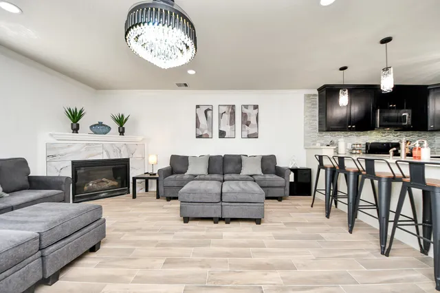 a bedroom with a bed painting on wall and a desk