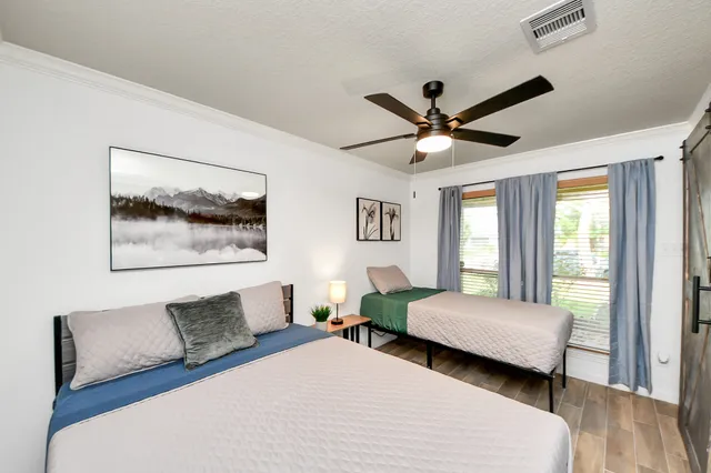 a bedroom with a bed and a couch