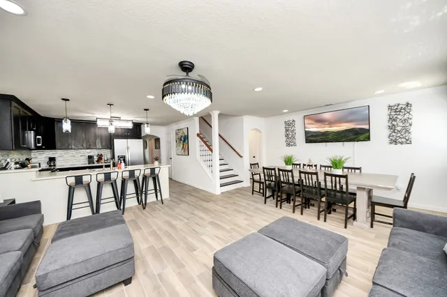 a living room with lots of furniture and a large window
