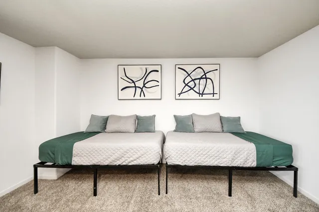 a bedroom with a large bed and a chandelier