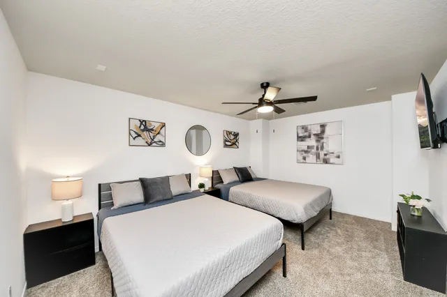 a bedroom with a bed and a chandelier