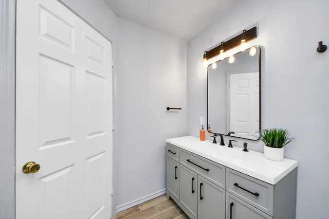 a spacious bedroom with a bed and a flat screen tv