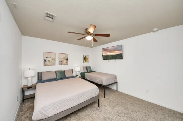 a bedroom with two beds and a chandelier