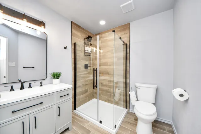 a bathroom with a sink toilet and shower