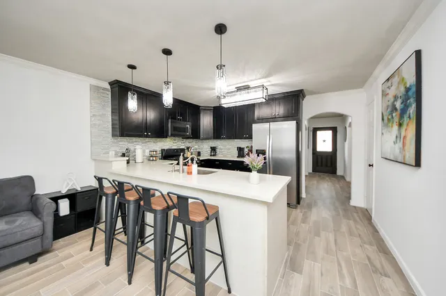 a kitchen with stainless steel appliances kitchen island granite countertop a sink and cabinets