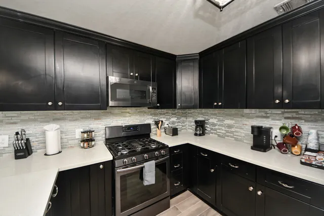 a kitchen with sink and cabinets