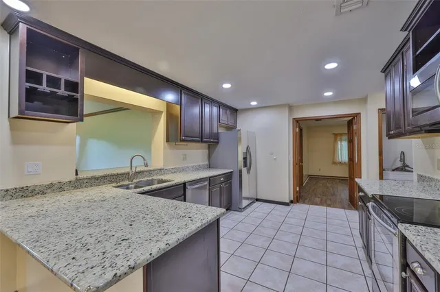 a kitchen with a sink stove and cabinets