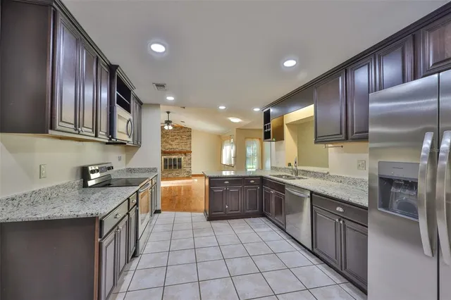 a kitchen with a sink stove top oven and cabinets