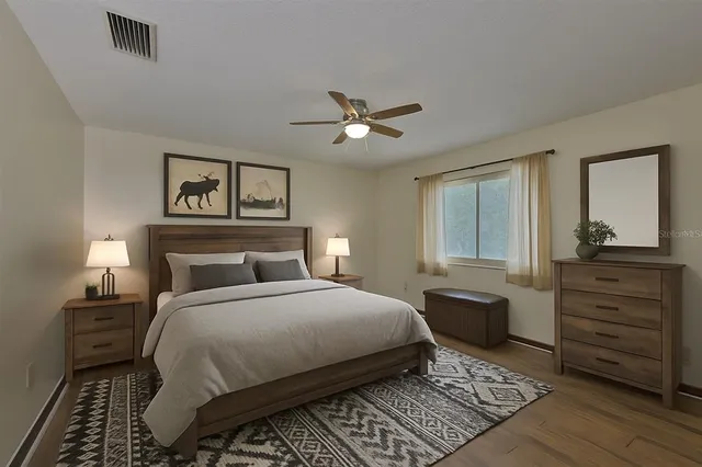 a bedroom with a bed and a dresser