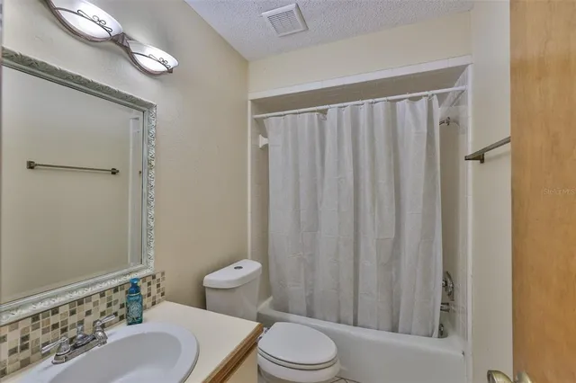 a bathroom with a toilet a sink and a shower