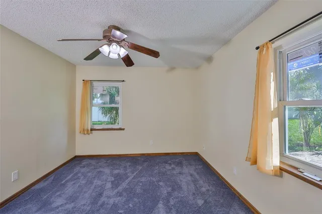 a view of a livingroom with a ceiling fan and window