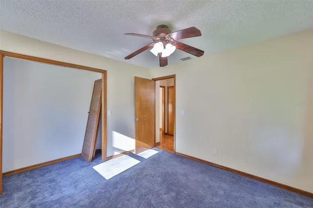 a view of room with window and ceiling fan