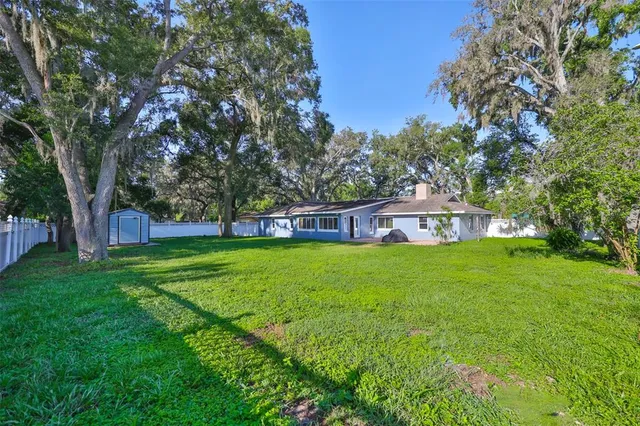 a view of a house with a backyard
