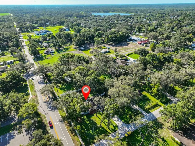 an aerial view of a house with a yard basket ball court and outdoor seating