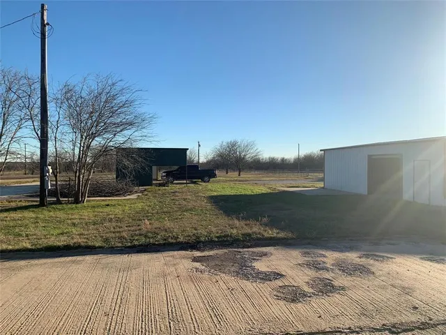 a view of a backyard with large trees