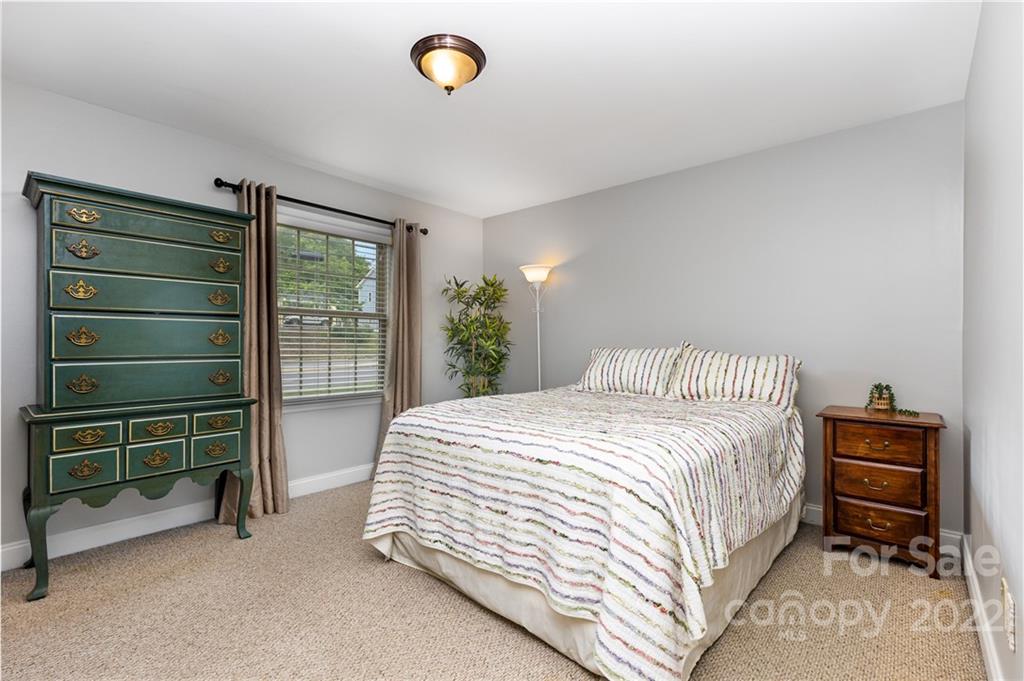 4915 Park Road, Unit C Charlotte, NC 28209 - Photo 12 of 22 a bedroom with a bed and a cabinets