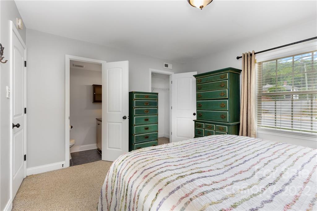 4915 Park Road, Unit C Charlotte, NC 28209 - Photo 13 of 22 a bedroom with a bed and a large window
