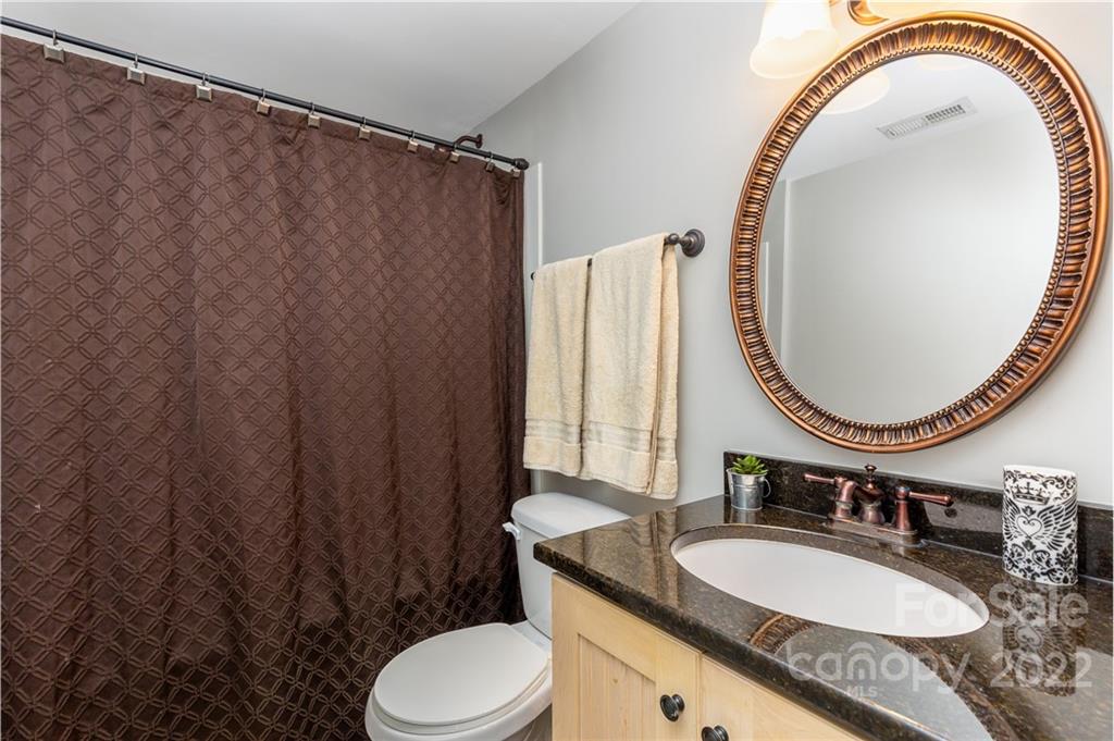 4915 Park Road, Unit C Charlotte, NC 28209 - Photo 14 of 22 a bathroom with a granite countertop sink and a mirror