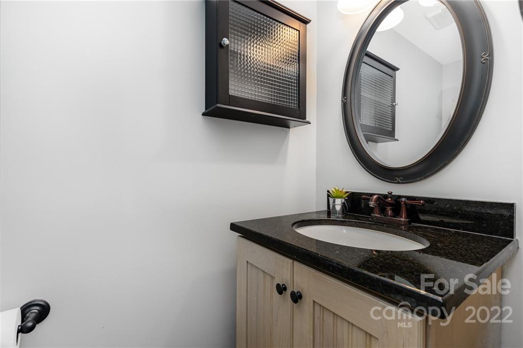 4915 Park Road, Unit C Charlotte, NC 28209 - Photo 17 of 22 a bathroom with a sink and a mirror