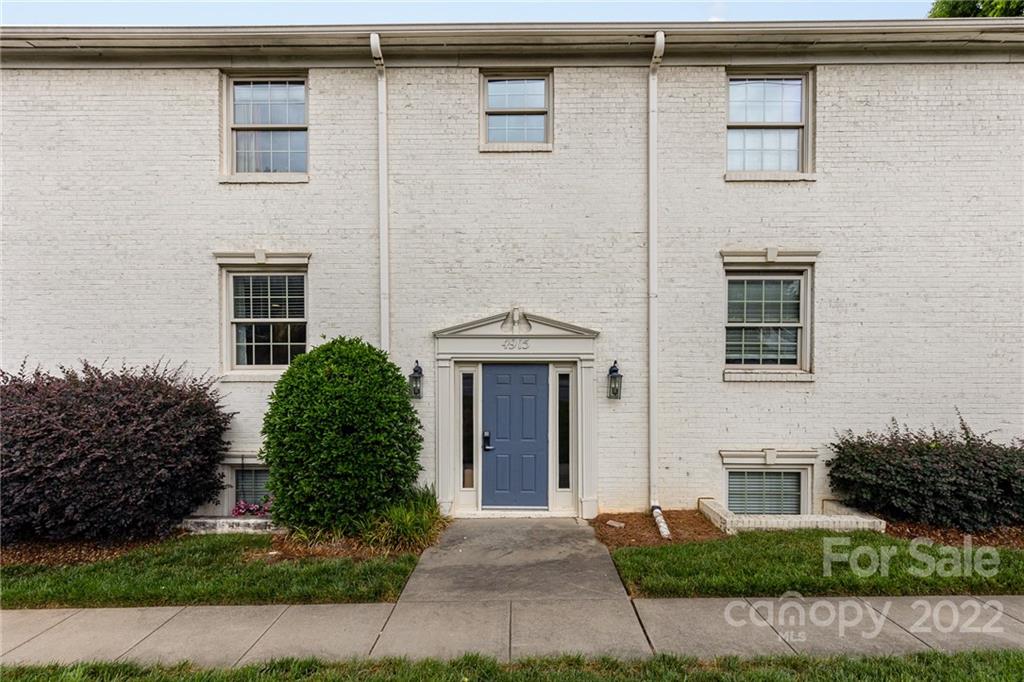 4915 Park Road, Unit C Charlotte, NC 28209 - Photo 18 of 22 a front view of a house with a yard and garage
