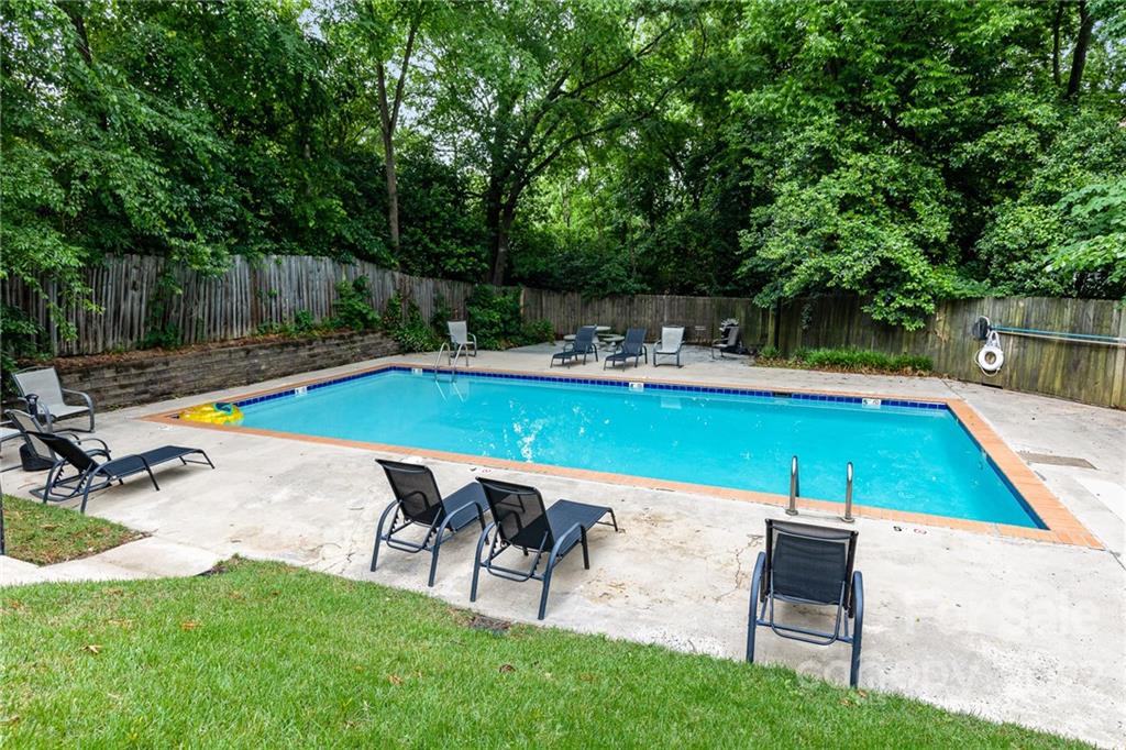 4915 Park Road, Unit C Charlotte, NC 28209 - Photo 21 of 22 a view of a swimming pool with lounge chair