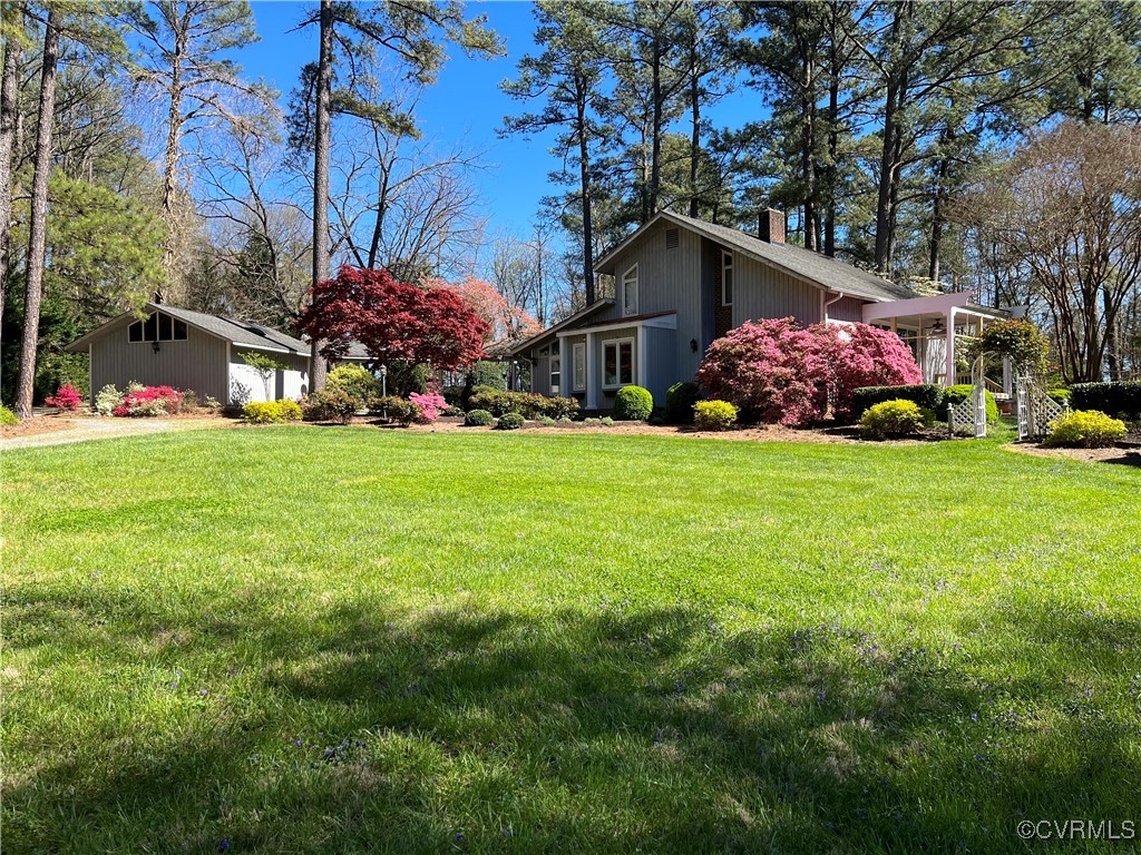 a front view of house with yard and trees