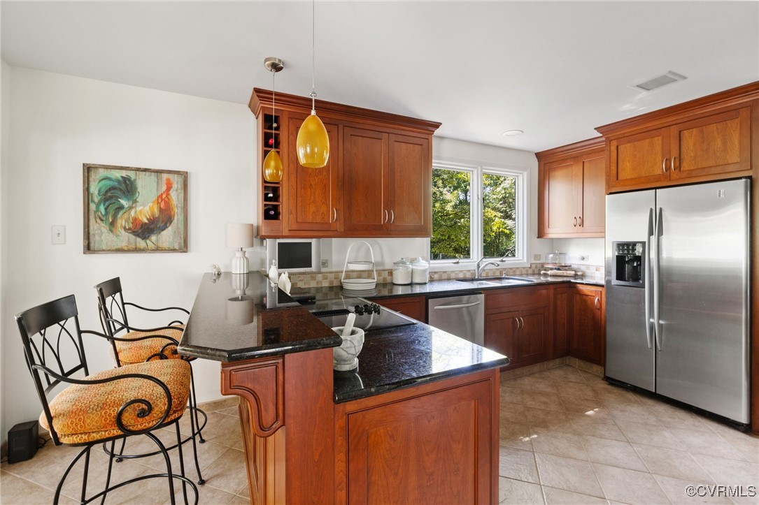 281 Echo Meadows Road Rockville, VA 23146 - Photo 12 of 50 a kitchen with stainless steel appliances granite countertop a sink refrigerator and cabinets