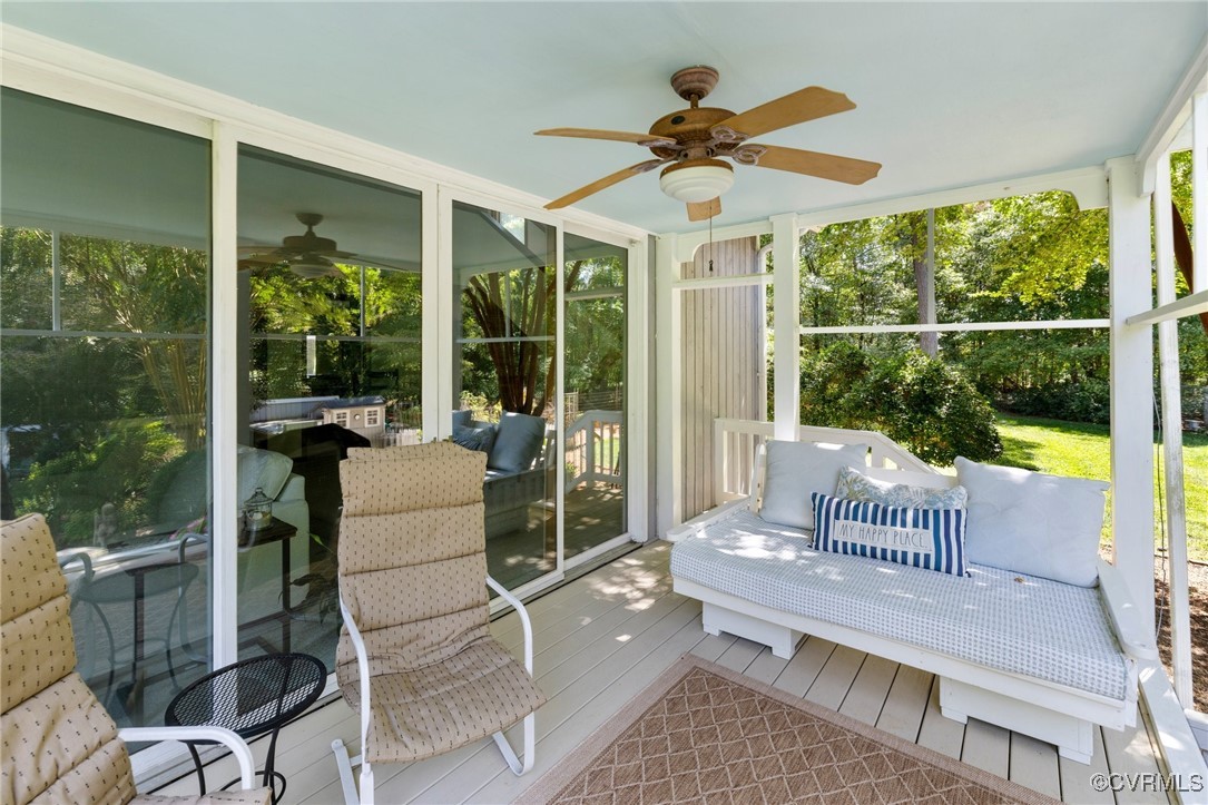 281 Echo Meadows Road Rockville, VA 23146 - Photo 40 of 50 a living room with a floor to ceiling windows and a table