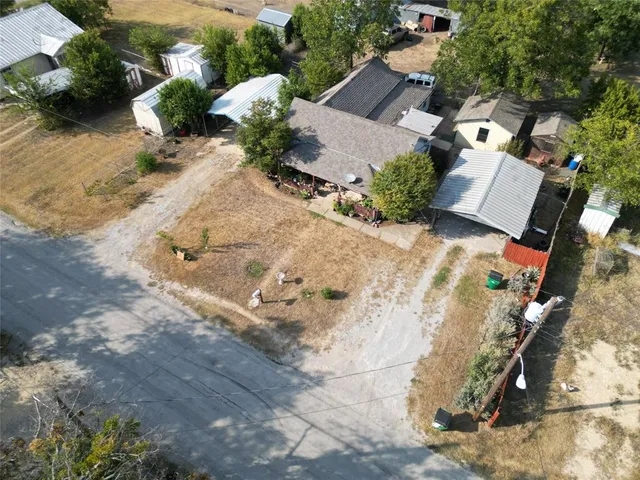 an aerial view of multiple houses with yard