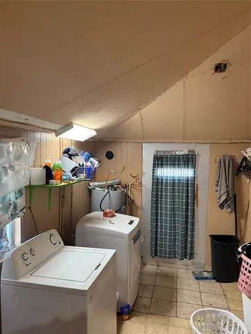 a room with a washing machine and sink
