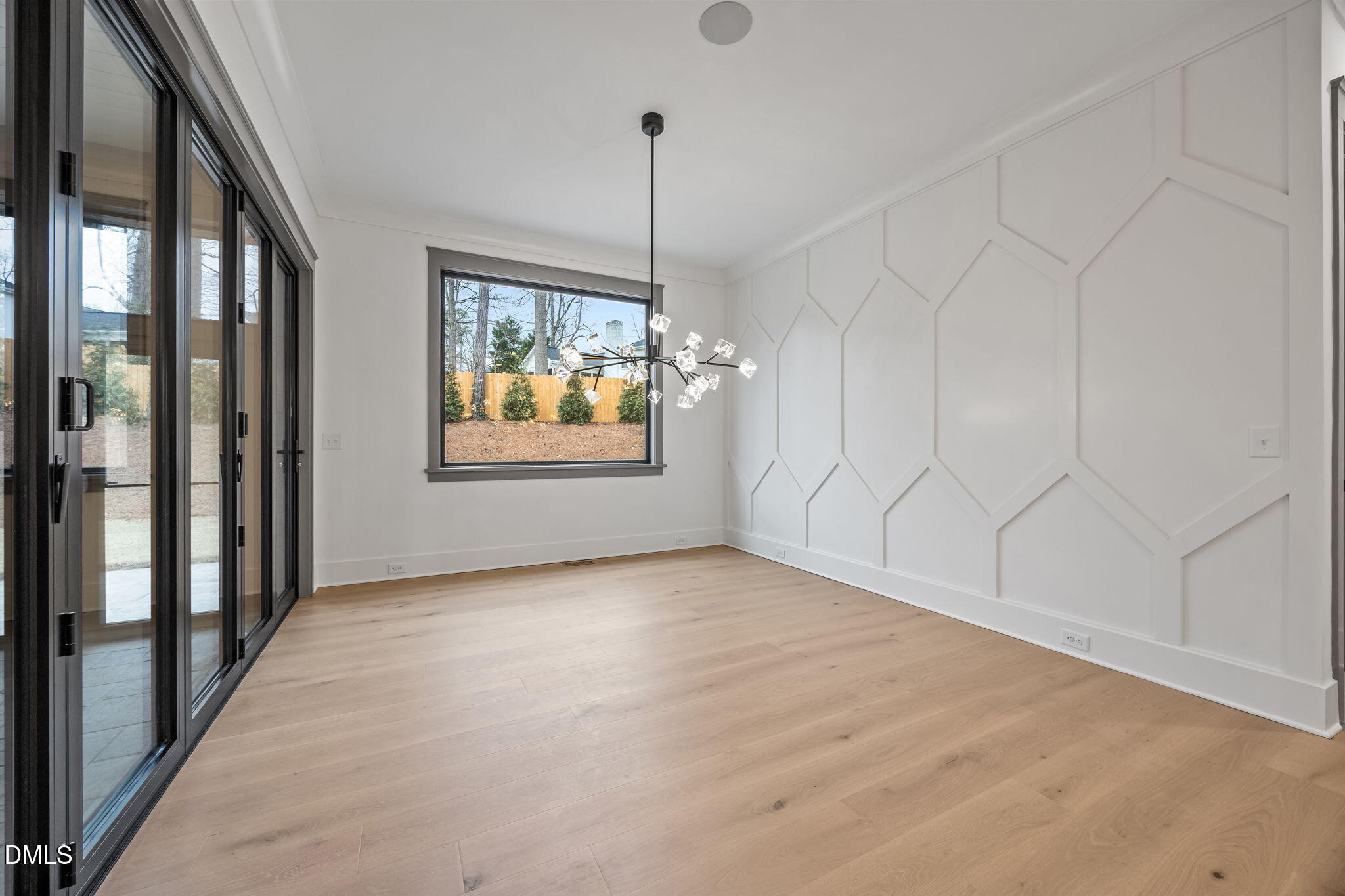 1312 Hunting Ridge Road Raleigh, NC 27615 - Photo 16 of 52 a view of an empty room with window and chandelier