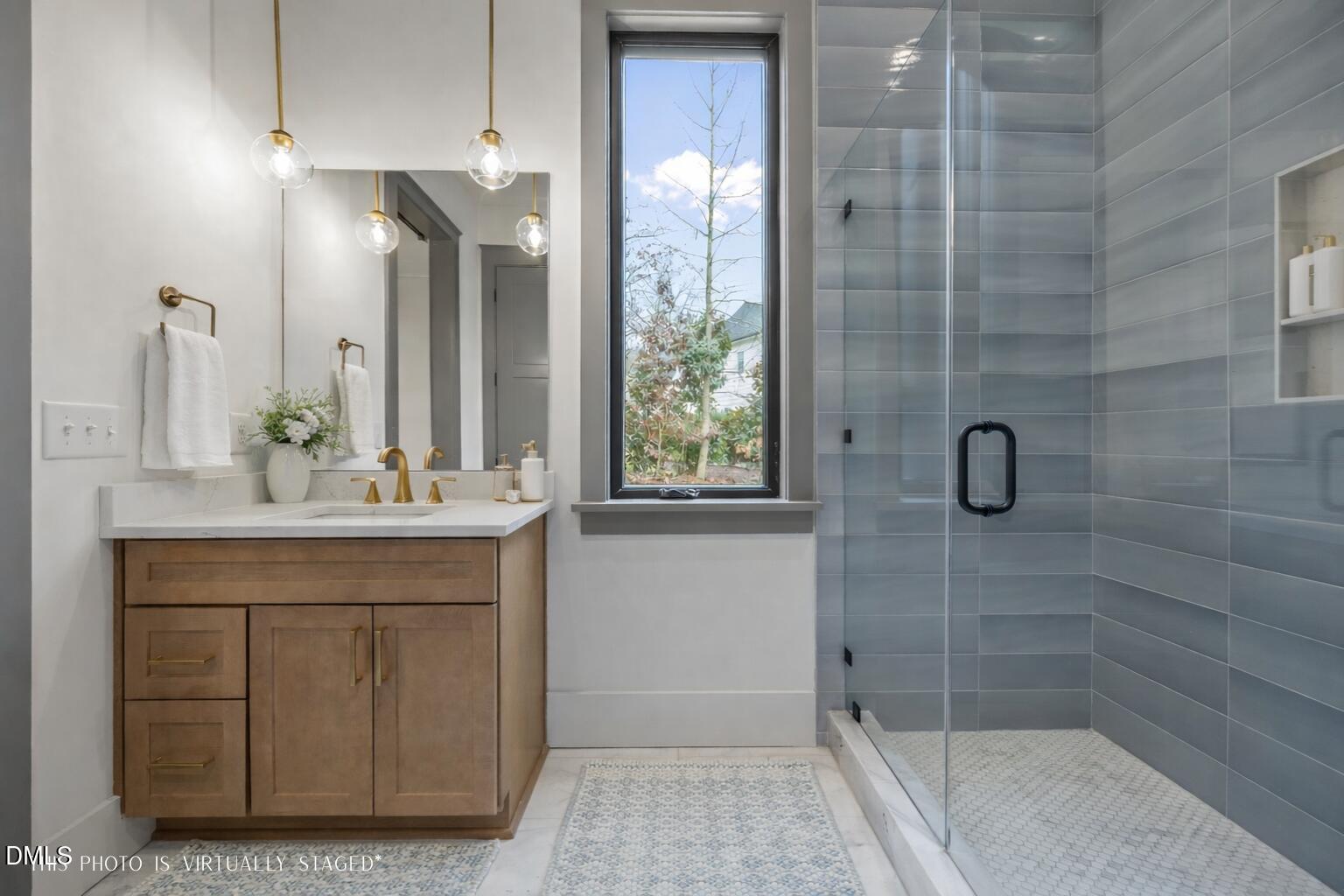 1312 Hunting Ridge Road Raleigh, NC 27615 - Photo 24 of 52 a bathroom with a shower a sink and a mirror