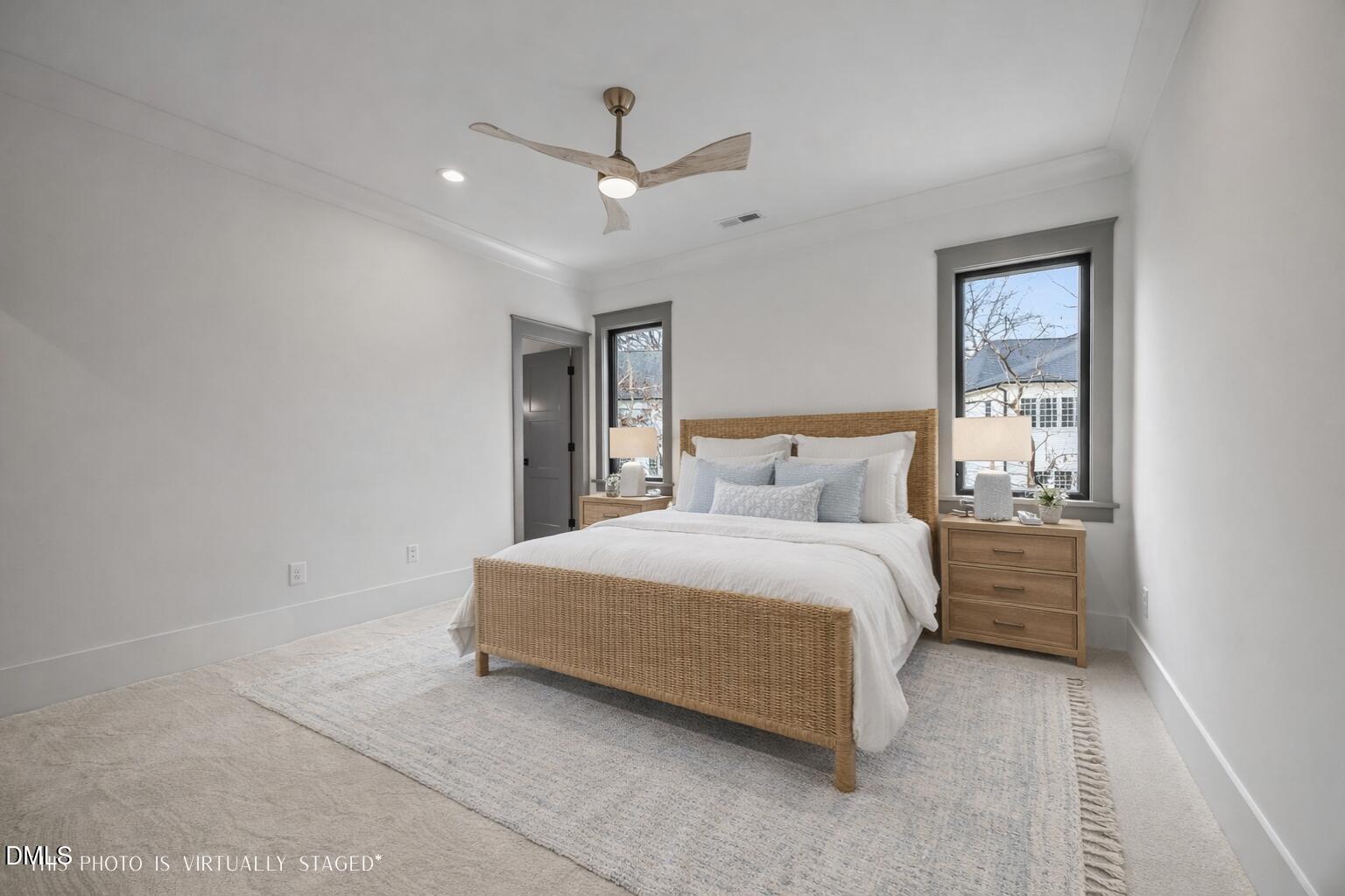 1312 Hunting Ridge Road Raleigh, NC 27615 - Photo 40 of 52 a bedroom with a bed and a ceiling fan