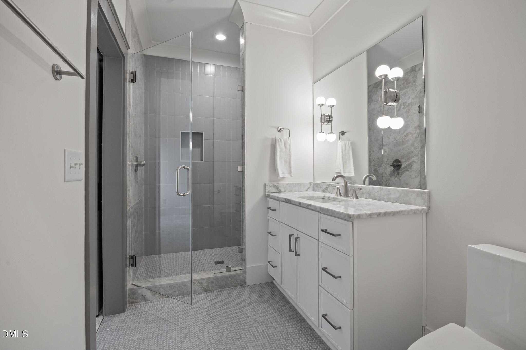 1312 Hunting Ridge Road Raleigh, NC 27615 - Photo 47 of 52 a bathroom with a double vanity sink and mirror with toilet