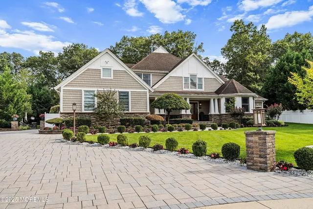 an aerial view of residential house with outdoor space and trees all around