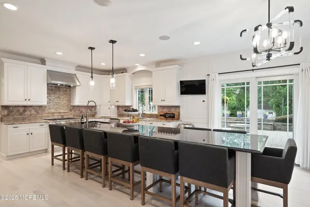 a large kitchen with lots of counter space and stainless steel appliances