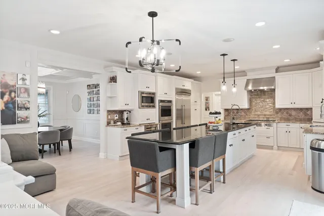 a kitchen with a dining table chairs and stove