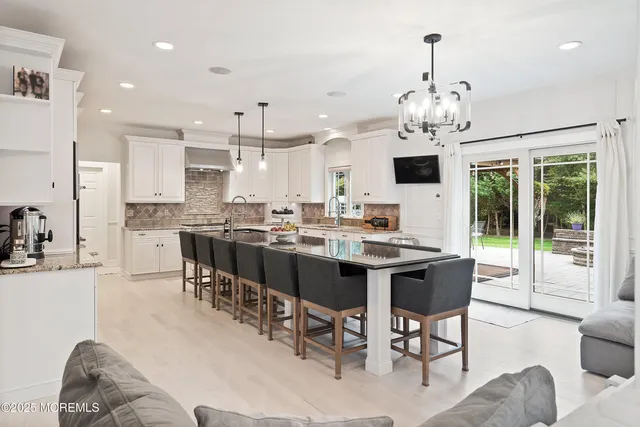 a kitchen with stainless steel appliances white cabinets and a refrigerator