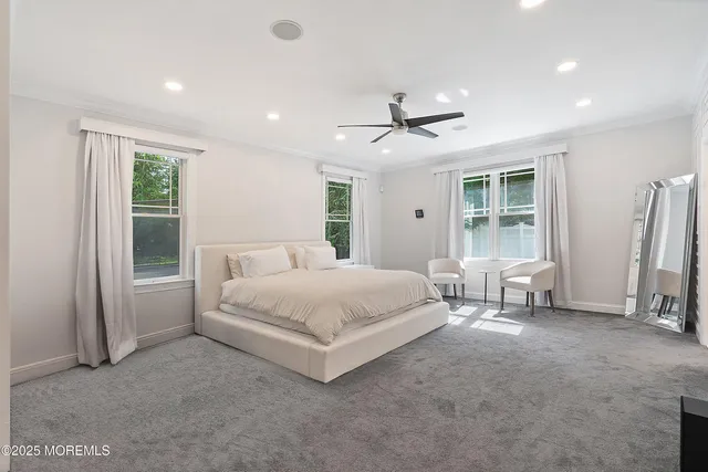 a spacious bedroom with a bed and a window