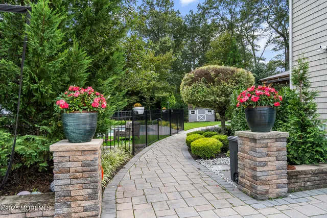 an aerial view of residential houses with outdoor space and pool