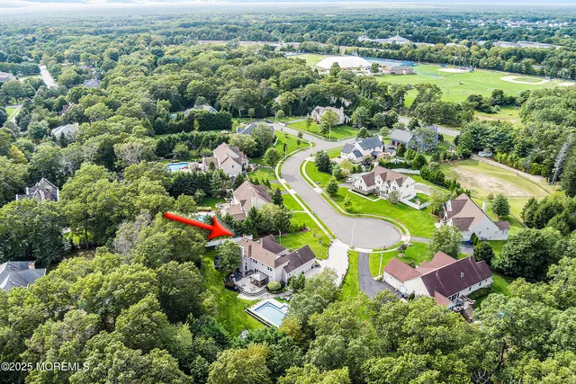 an aerial view of a house with pool yard and outdoor seating