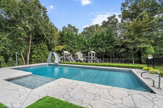 a front view of house with yard swimming pool and outdoor seating