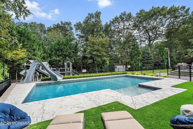 an aerial view of a house with pool yard and outdoor seating