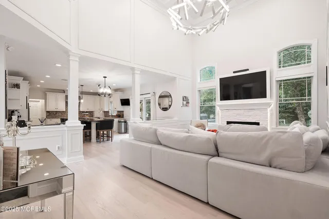 a living room with furniture and view of kitchen