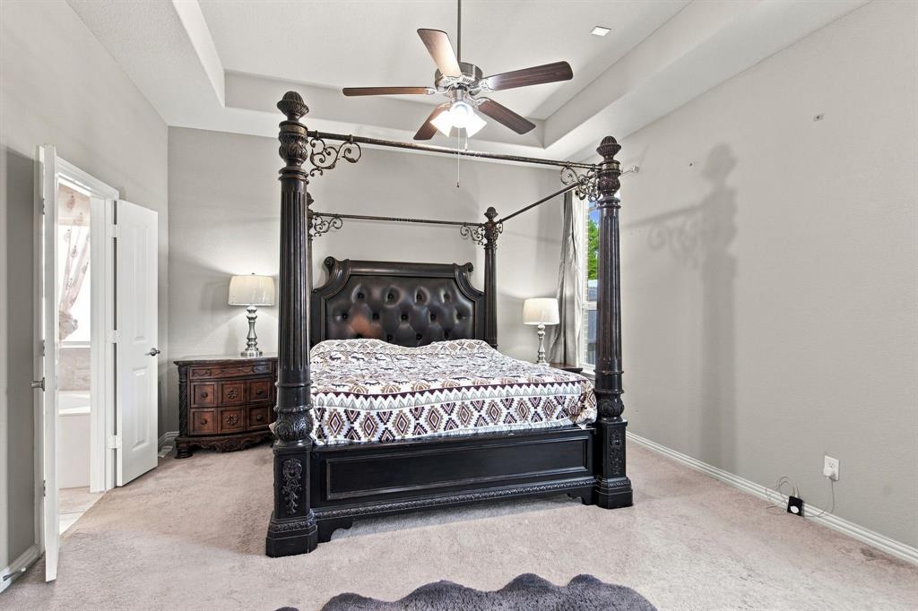3908 Ranchman Boulevard Denton, TX 76210 - Photo 12 of 29 Tray ceiling with recessed lighting, ceiling fan, and light-toned wall finishes