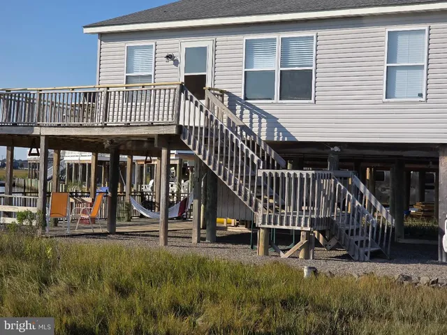 a view of a house with a deck and a yard floor