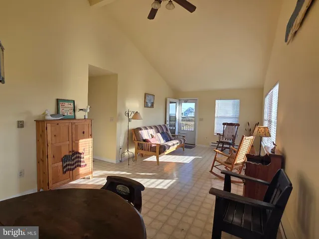 a living room with furniture gym equipment and a window