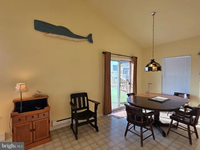 a view of a dining room with furniture and window